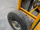 a close up of a forklift with a tire on it