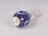 a blue and white vase sitting on a white surface