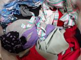 a basket full of clothes that is sitting on a bed