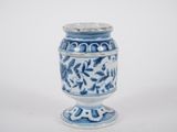 a blue and white vase sitting on a white surface
