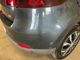 the rear end of a car with a sticker on it ' s bumper
