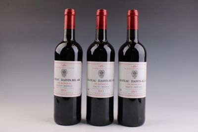 trois bouteilles de vin rouge posées côte à côte sur une table
