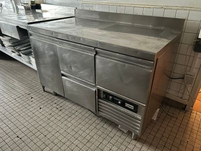 a large stainless steel counter in a commercial kitchen
