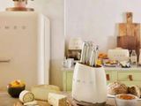 a table with a bunch of food on it and a refrigerator in the background