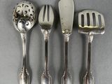 four spoons and a spatula sitting on top of a table