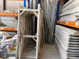 a forklift in a large warehouse with lots of pallets