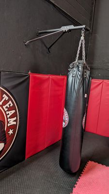 a black and red boxing bag next to a black and red punching bag