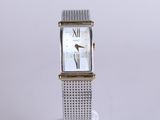 an image of a close up of a wrist watch on a stand