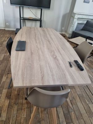 un parquet dans une pièce équipée d'une table, de chaises et d'une télévision à écran plat accrochée au mur
