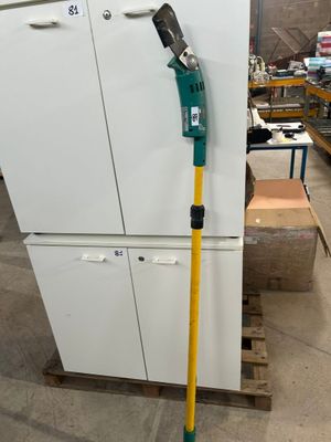 a picture of a white refrigerator in a warehouse with a handle on it