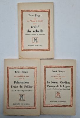 three books on a white table with a red border
