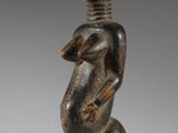 an image of a wooden statue of a man with a bird on his shoulder