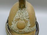 a helmet that has a gold decoration on it