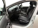 the interior of a car with the door open and the driver ' s seat down