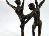 statue of a couple of ballerinas holding each other ' s hands