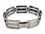 a close up of a metal bracelet on a white background