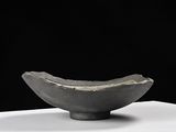 a black bowl that is sitting on a white table