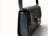 an image of a black purse on a white background
