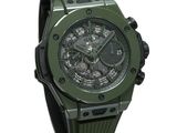 the watch is green and has a black rubber band