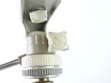 a close up of a camera on a tripod with a white background
