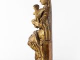 a statue of a woman holding a child on her lap