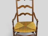 an old wooden chair with a yellow seat and a yellow cushion