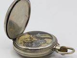an image of a silver pocket watch on a white surface