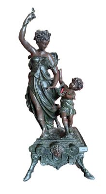 bronze statue of a woman and a child on a table