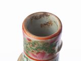 a small cup with a saucer sitting on a saucer