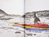 an open book with a picture of a person on a surfboard