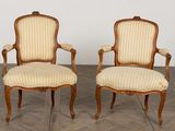 pair of louis xv style carved wood armchairs with upholstered upholstered arms