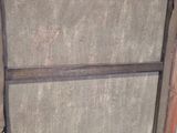 an old wooden frame with a piece of fabric hanging from it