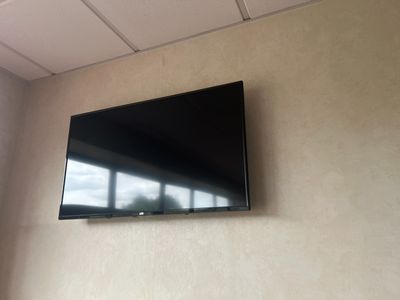 un téléviseur à écran plat fixé au mur d'une pièce