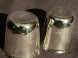 two silver salt and pepper shakers sitting on a table