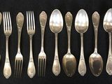 a lot of spoons and forks on the table