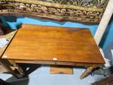 a small wooden table with a drawer underneath it