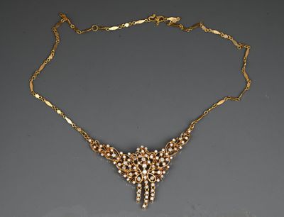 a gold necklace with pearls on a chain