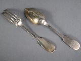 two silver spoons and a fork on a table
