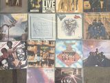 many different album covers on the wall of a room