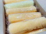 six rolls of wax in a box on a table