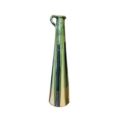 un vase vert muni d'une anse sur fond blanc