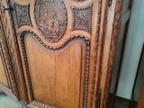 a wooden cabinet with a mirror on top of it