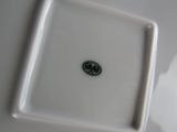 a white plate with a black and white logo on it