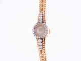 a close up of a wrist watch with a chain around it