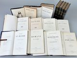 several old books are stacked on top of each other on a table