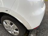 a white car that is parked on the side of the road