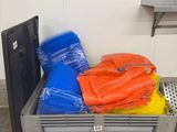 a plastic crate filled with orange and blue bags