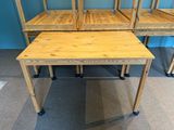 three wooden desks sitting next to each other on the floor