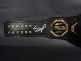 a close up of a black belt with a gold buckle