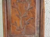 a wooden frame with a flower carved into it